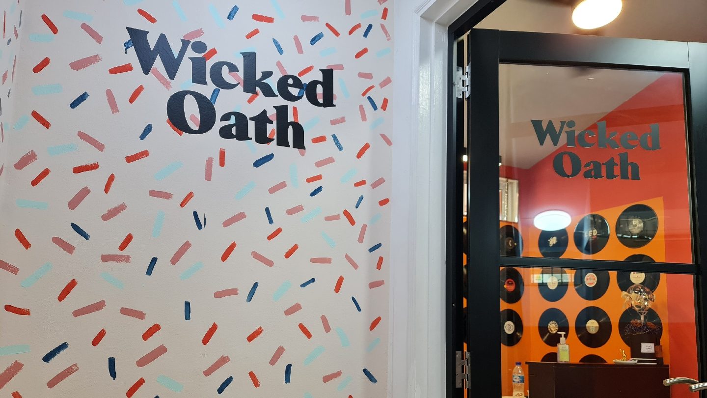 The Wicked Oath studio wall and entrance